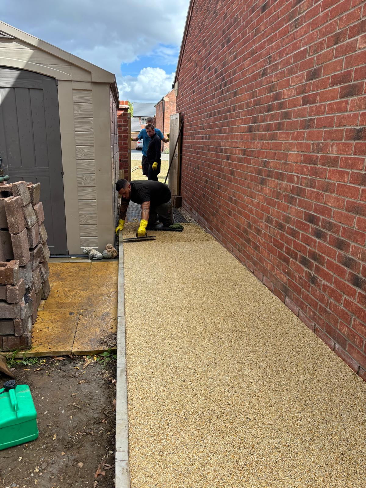 9a58d12b-548c-4d6c-9342-05c92906aa09 Burgh Resin laying resin bound surfacing around a house in Glasgow