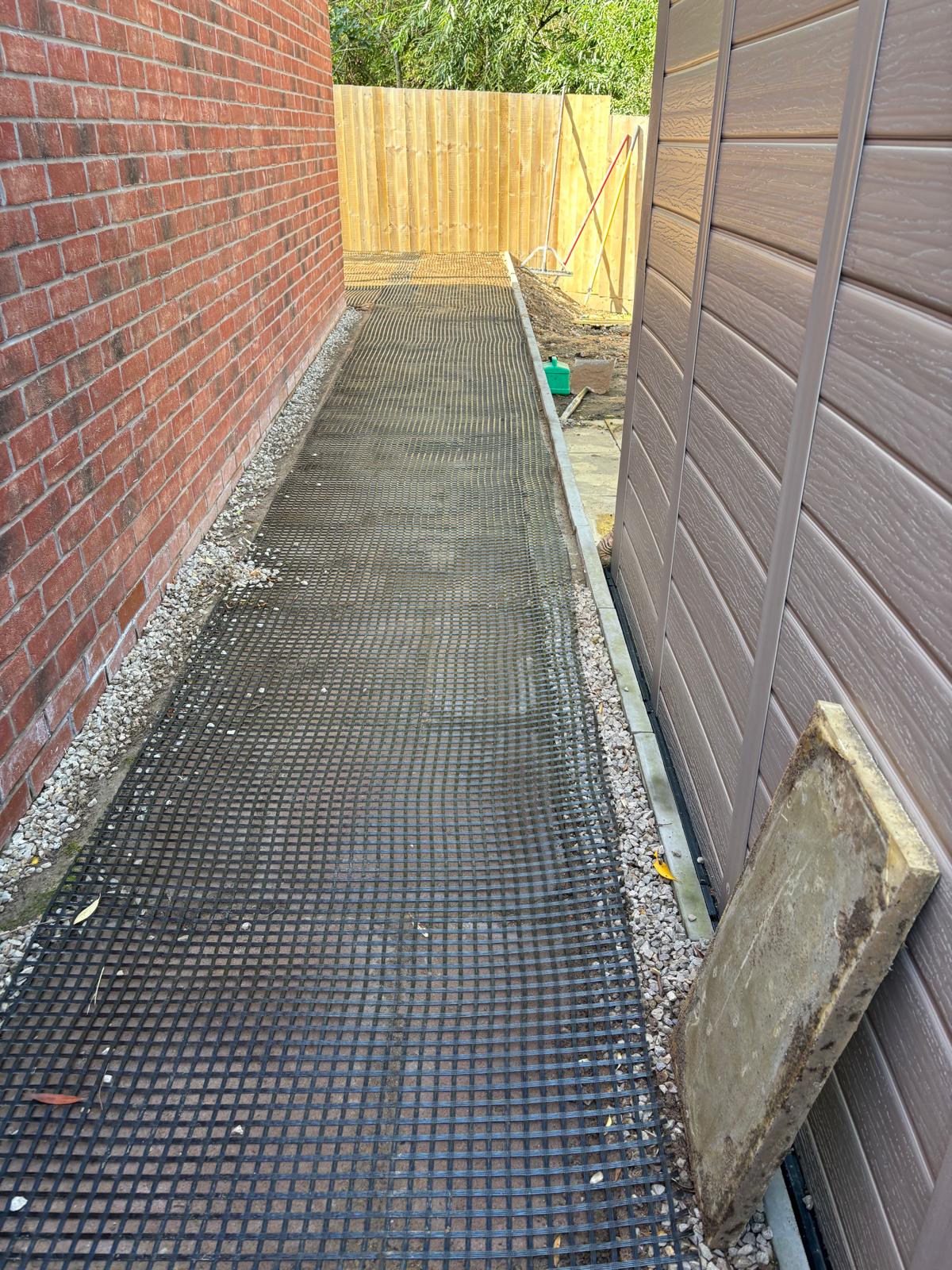 d9257e73-5bea-4a48-9637-03e4da685256 Mesh layer being laid before adding a resin bound surface for a path in Glasgow